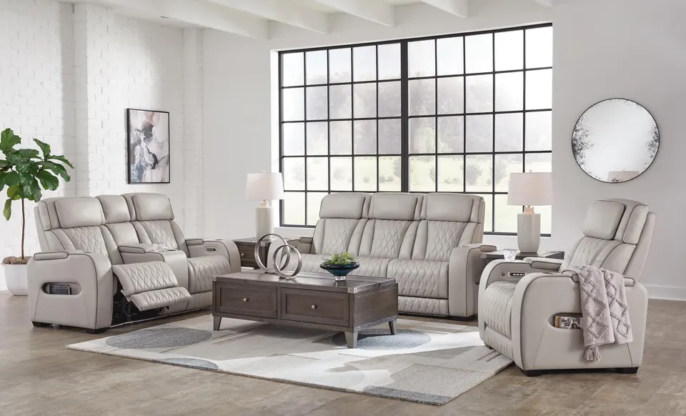 Power reclining sofa, loveseat and recliner in a bright loft living room
