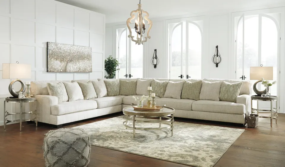 Ashley Rawcliffe cream sectional with round coffee table in a bright living room with arched windows