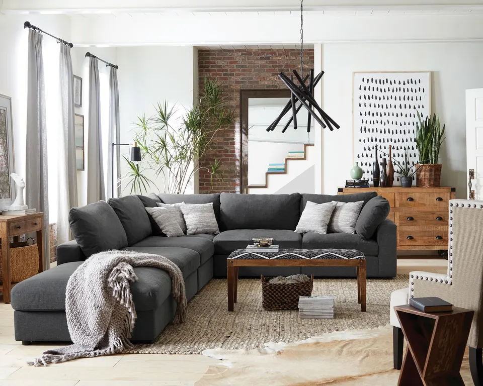 Coaster Serene charcoal modular sectional in a loft living room with a brick wall